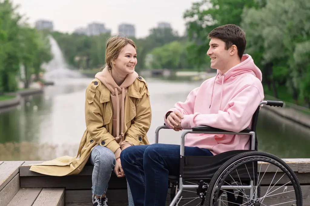 Two young people talking through plans together by a river